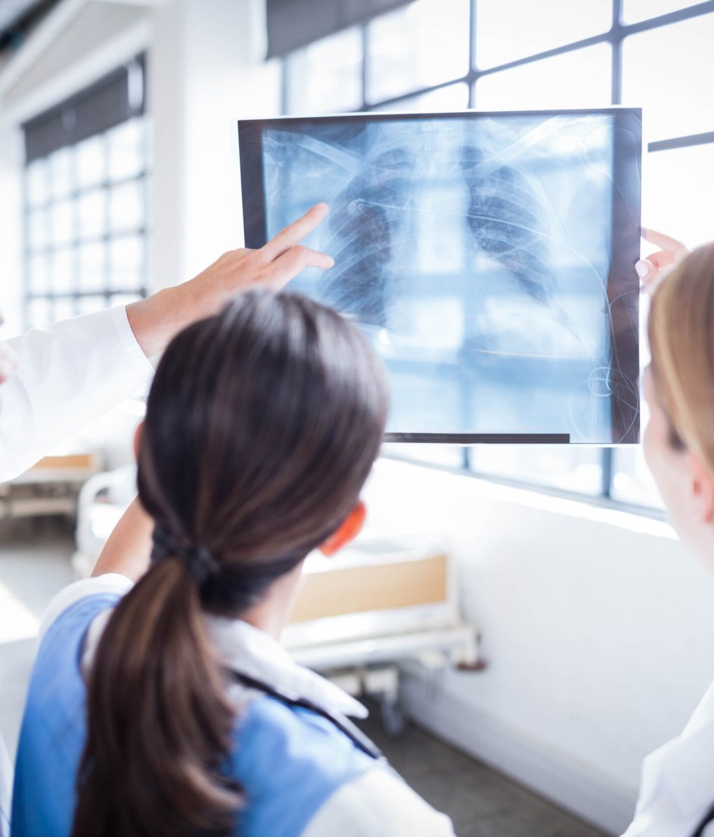 Medical team looking at x-ray together at hospital